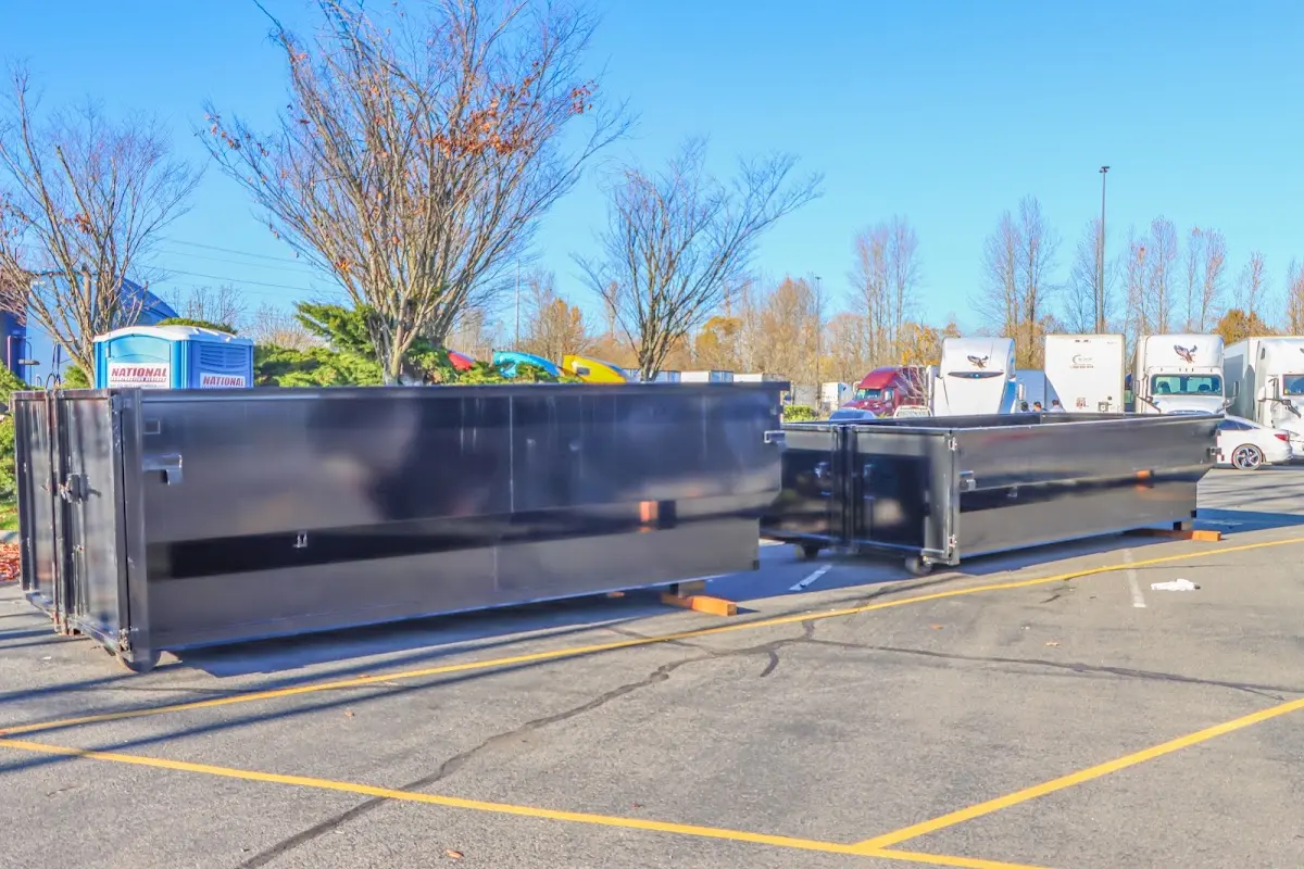 Professional dumpster rental service with roll-off container on residential driveway in Kailua
